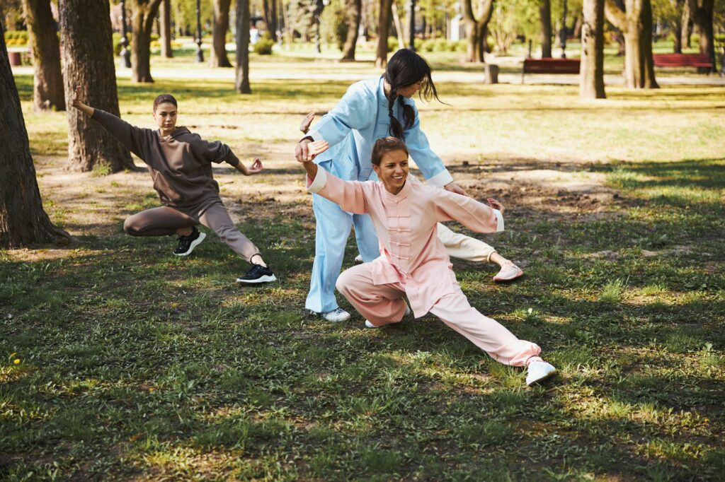 Martial arts instructor putting student hands in correct position